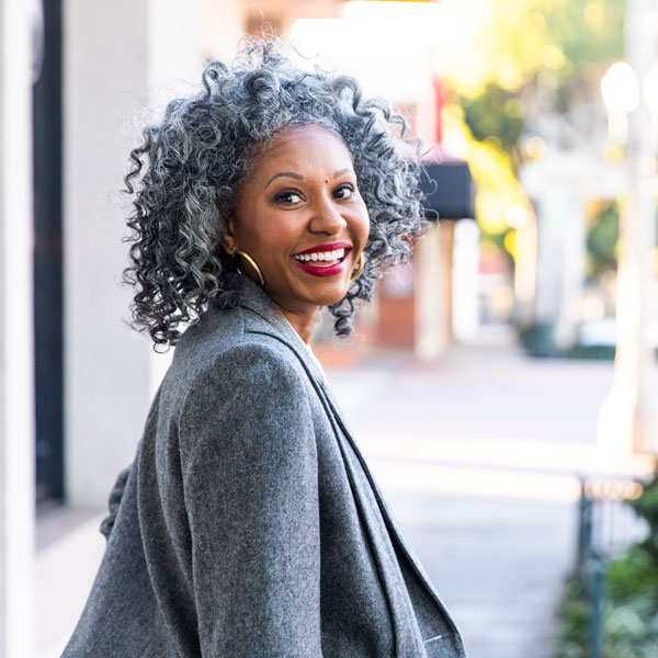 woman smiling while walking outside