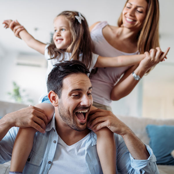 family of three smiling together
